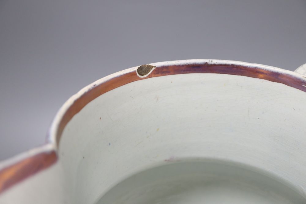 A Victorian pink and copper lustre jug, with moulded floral panels, height 23cm (crack to base)
